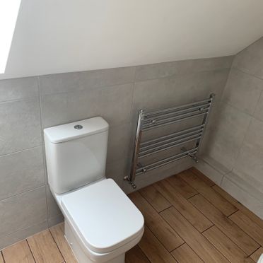 Bijou Rimless C/C Toilet; 500 x 800 Chrome Towel Warmer. Canvas Grey Tiles.